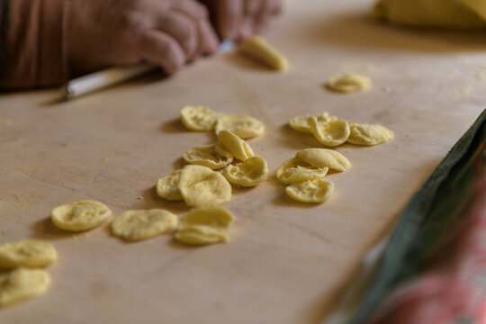 Female hans making apulian pasta orecchiette