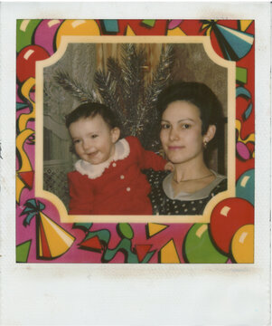 A Joyful Mother Holds Her Smiling Child in Festive 1994 Snapshot