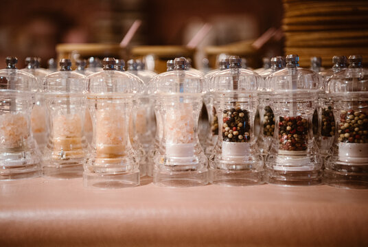 modern pepper and salt mills on display at a stylish eatery.