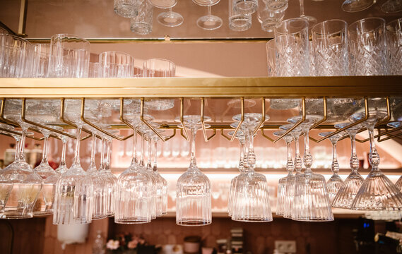 hanging crystal glassware adds elegance to the modern bar decor.