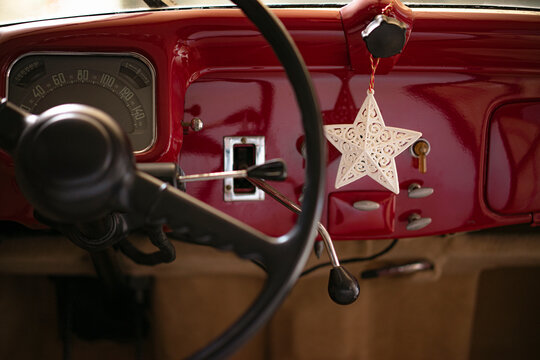 Fototapeta Steering wheel and front panel of a red classic car with star sh