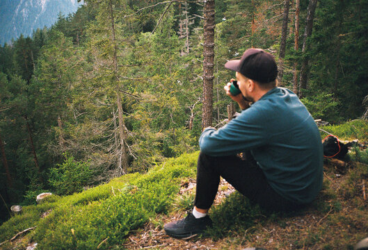 Anonymous man drinking tea in the mountains