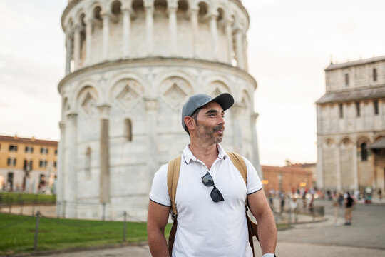 tourist walking around the tower of pisa in toscany, italy