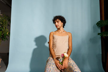 A woman poses elegantly with flowers 