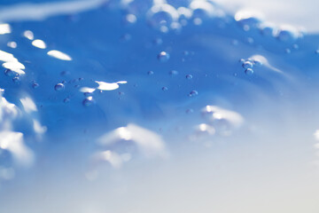 Macro shot of pouring water in container