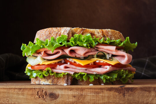 Sandwich with Ham, Cheese, Lettuce, and Tomato on Rustic Bread