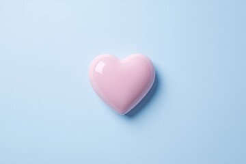 Obraz premium Pink heart-shaped object on light blue background
