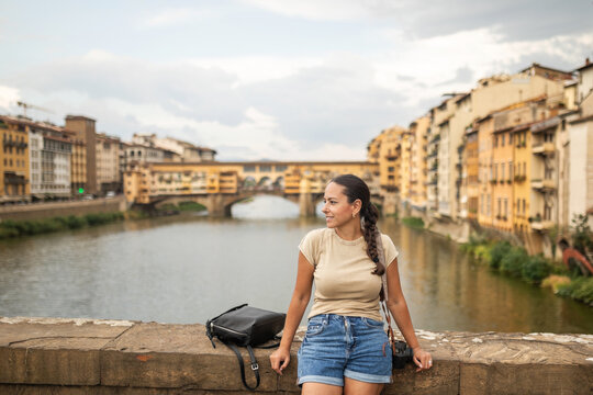 tourist woman standing on a Trinity Bridge in florence in italy
