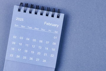 February 2025 Monthly desk calendar for 2025 year on blue background.