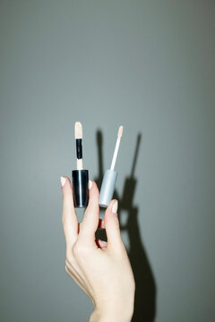 Hand holding make-up beauty product concealer with hard flashlight