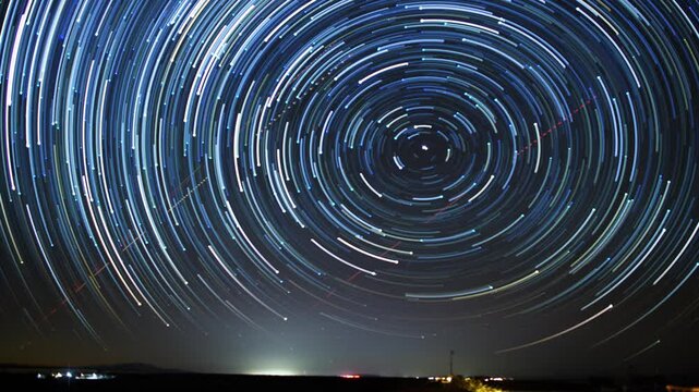Night sky with north star star trail.