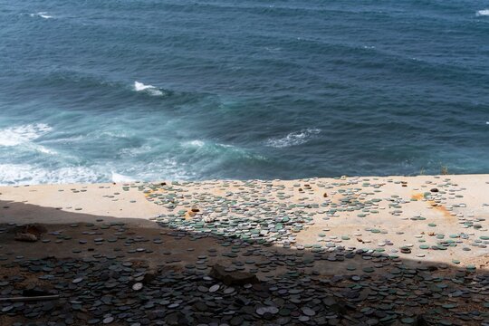 Coins left at Castillo San Crist&oacute;bal overlooking the ocean
