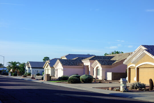 Typical southwestern single family housing community  with low watering xeriscaped front yards in Phoenix, Arizona; copy space