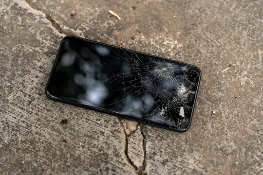 Smartphone broken screen on Ground