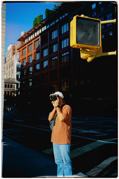 Film pic of tourist photographer using a camera to photograph New York