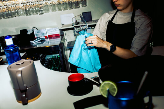 Bartender cleaning glass in restaurant