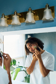 Man Using Jade Roller for Skincare