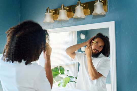 Man Using Jade Roller for Skincare