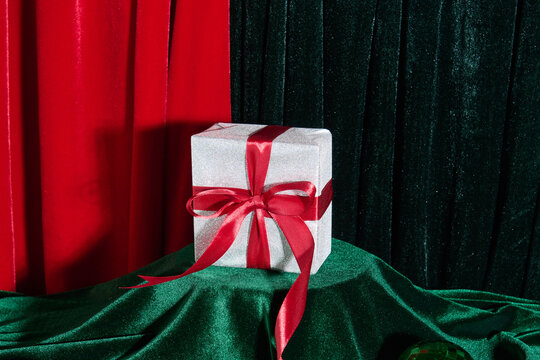 Elegant Gift Box with Red Ribbon on Festive Background