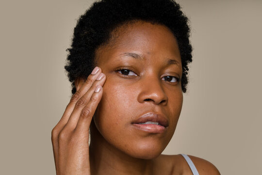 woman touching her face examining skin texture