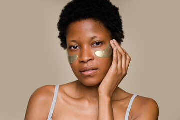 woman applying under eye patches for skincare routine