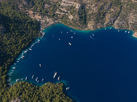 Aerial image of a bay filled with boats enjoying nature