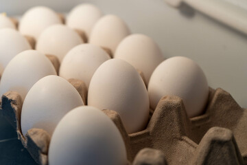 Eggs neatly arranged on a refrigerator shelf, emphasizing freshness and organization.