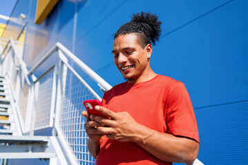 Smiling Man Using Smartphone Outdoors