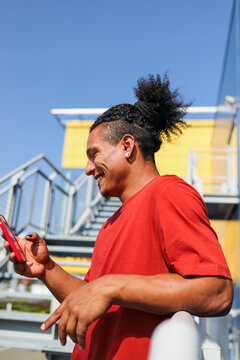 Man using phone under bright blue sky