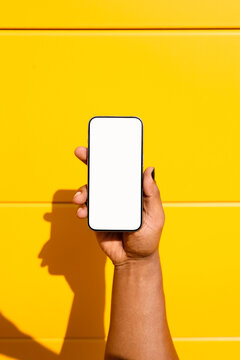 Hand Holding Smartphone with Blank Screen. Mockup phone