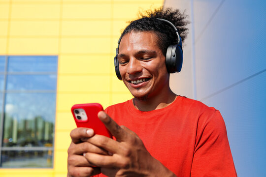 Happy Man Wearing Headphones Outdoors
