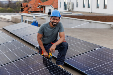 Happy male engineer at solar plant on rooftop