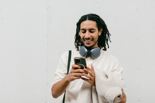 Modern businessman traveling checking smartphone - Powered by Adobe