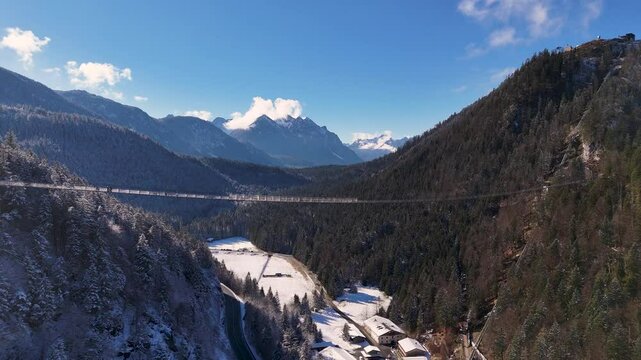 Suspended Highline179 bridge stretching over a forested valley in Austria