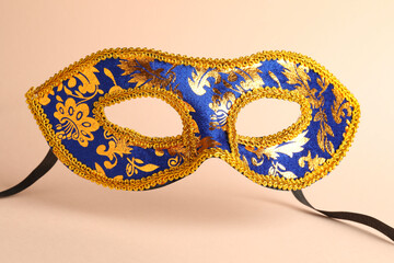 Beautiful bright carnival mask on beige background