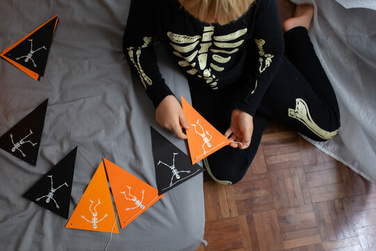 boy make Halloween skeleton flags garland 