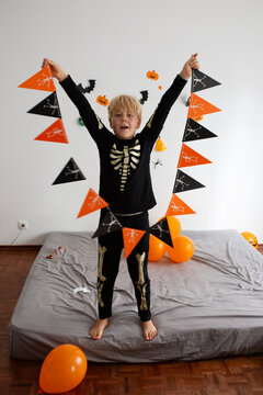 boy make Halloween skeleton flags garland 
