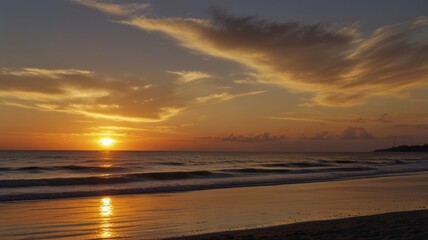 Obraz premium Golden sunset over a tranquil beach.