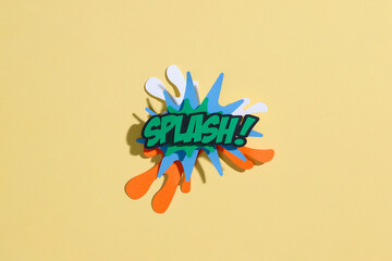 Colorful Comic Book Style 'Splash!' Text Cutout on Yellow Background