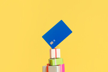Credit Card Levitation Over Colorful Gift Boxes Against Pastel B
