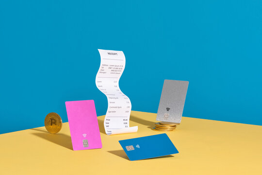 Bitcoin And Credit Cards With Cash Receipt On Colorful Background