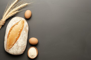 Fresh Artisan Bread with Eggs and Wheat on Rustic Dark Background