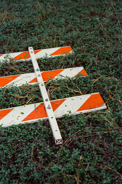 Film Snapshot of Fallen Road Block Sign on Grass