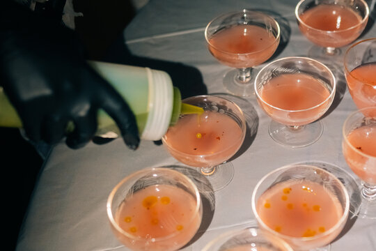 Bartender preparing cocktails with dropper at a party