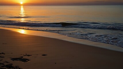 Golden sunrise over tranquil ocean beach shoreline with soft waves and wet sand.