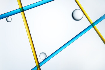 Abstract blue and yellow lines intersecting with glass spheres
