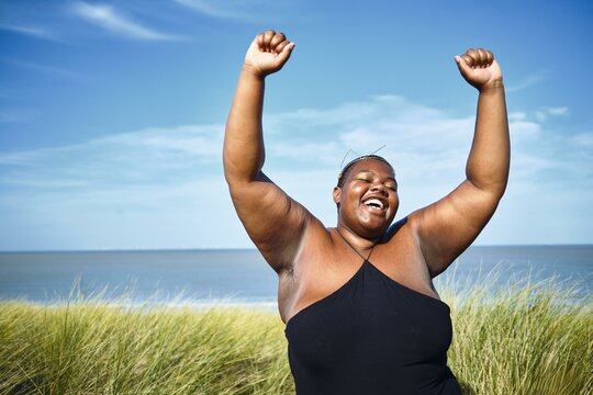 Joyful woman celebrates on a sunny beach day