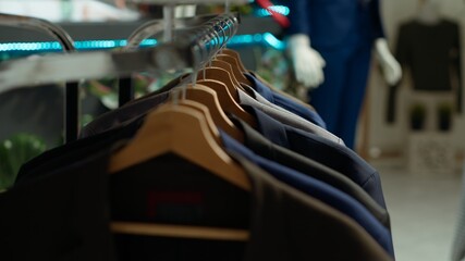 Elegant display of casual and formal clothing items in a retail store at the mall, inviting shoppers to explore a new designer collection. Trendy fashion essentials on hangers.