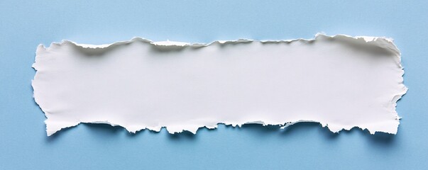 Fototapeta premium White torn paper piece revealing blue background with copy space