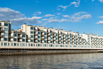 Fototapeta premium Residential waterfront apartment building. Waterfront architecture. Building with residential apartment at the river. Riva Pointe residential apartment building. modern architecture